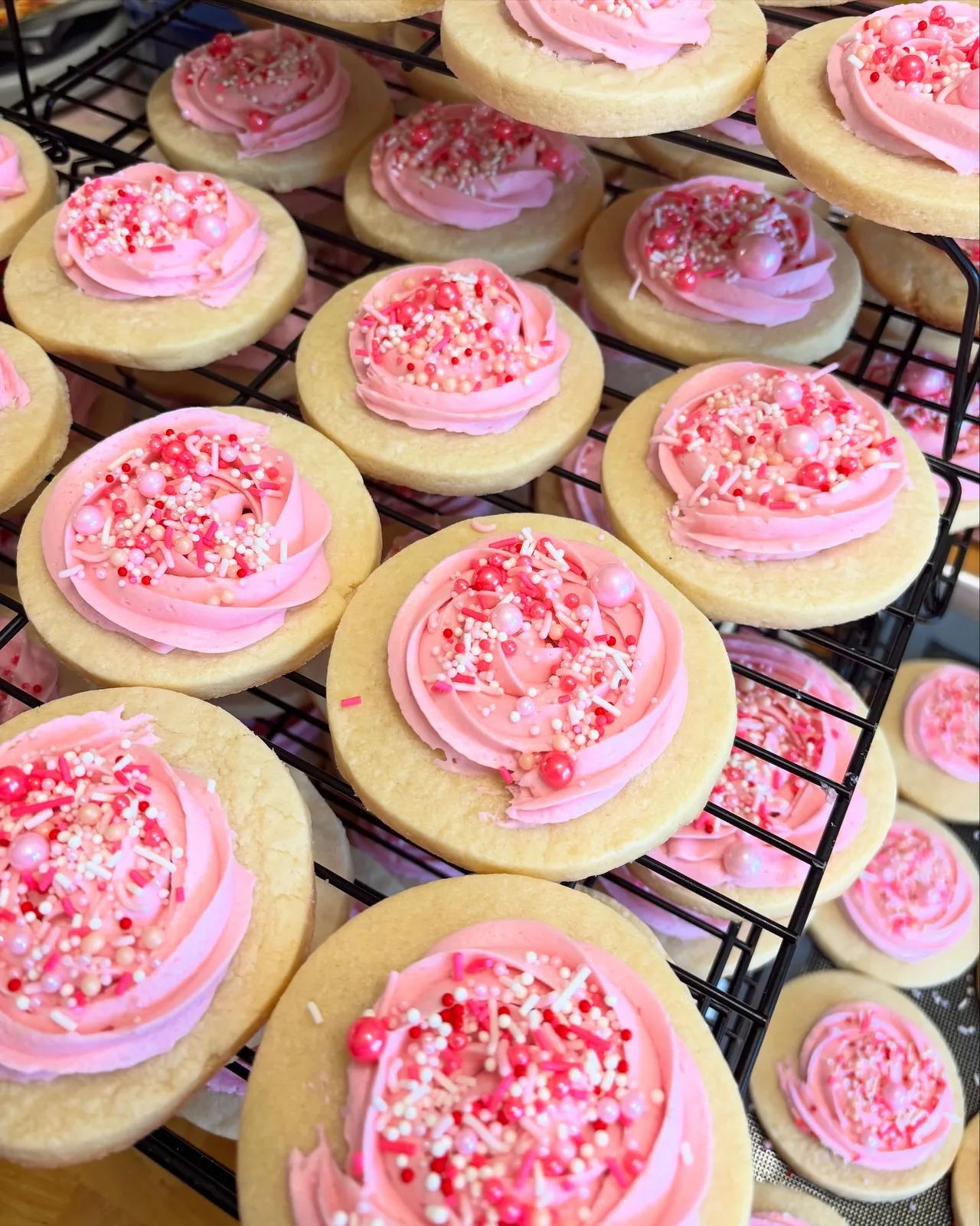 Pink floral sugar cookies prepared for a corporate event