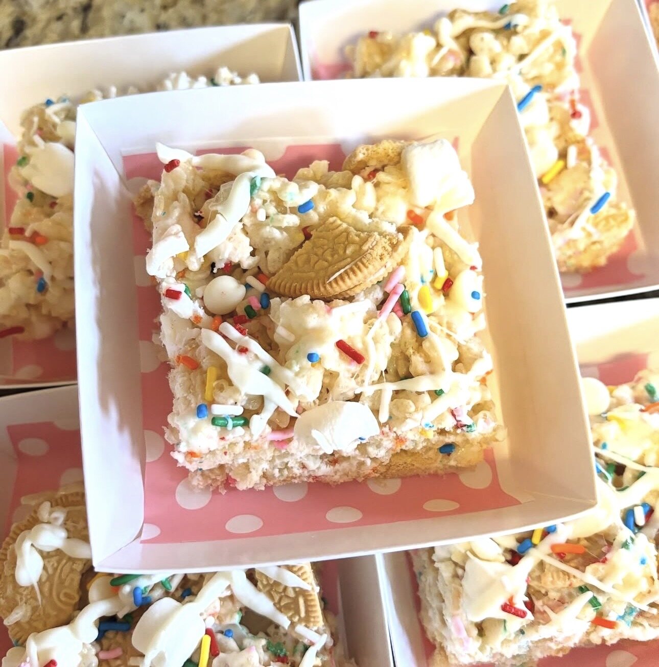 Gourmet Rice Krispy treats topped with cookies and colorful sprinkles